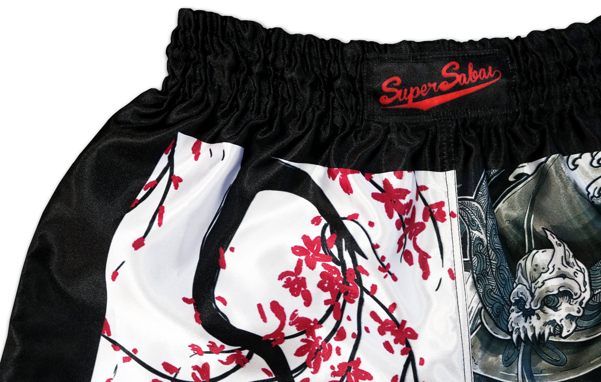 Close-up of the Cherry Blossom Samurai Muay Thai Shorts waistband, showcasing the Super Sabai logo and intricate sakura tree design, handcrafted in Thailand by our family business.