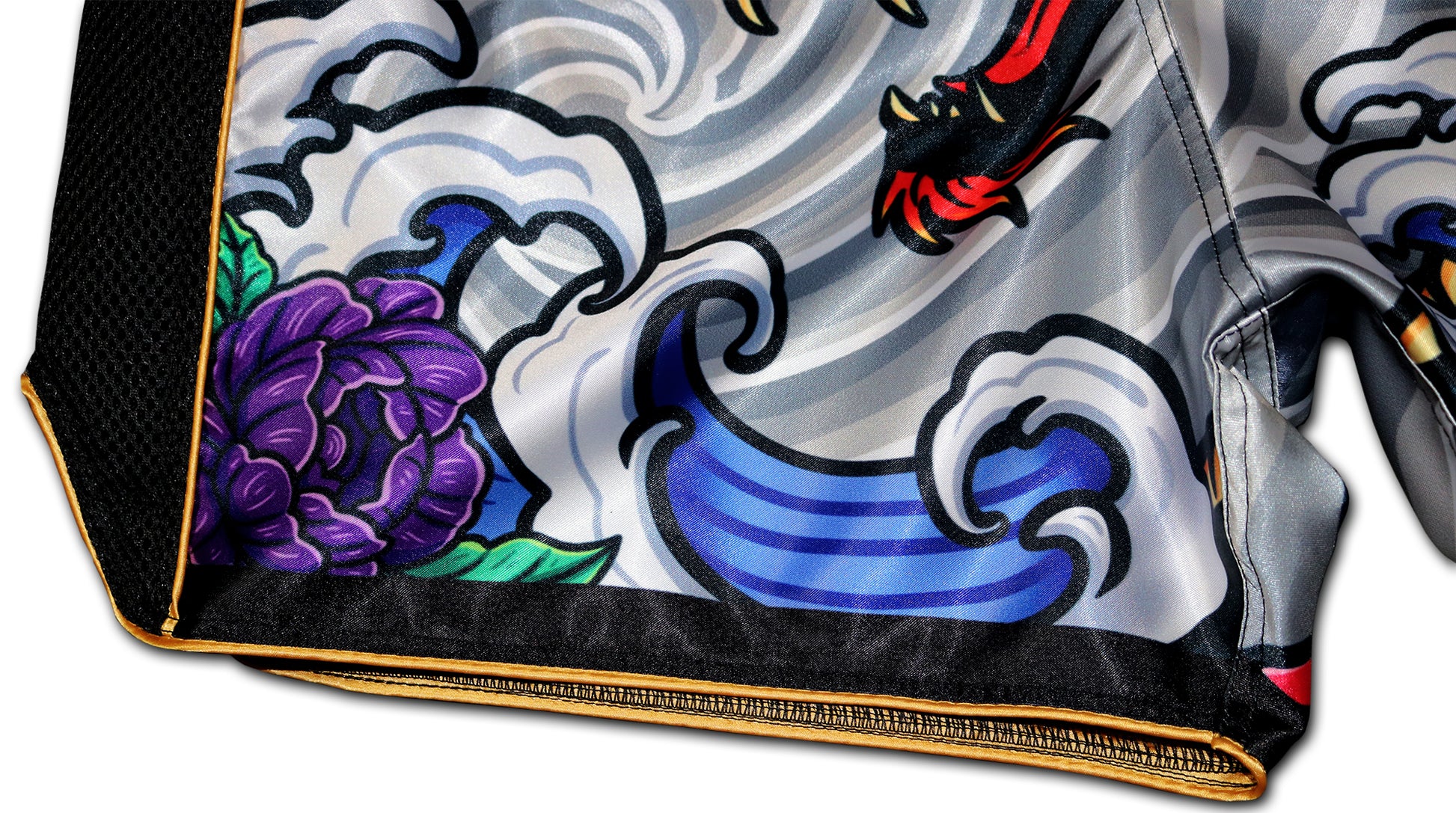 Detailed view of the Irezumi Dragon Muay Thai Shorts, featuring a vibrant purple flower and stylized wave patterns, showcasing the intricate artwork and premium stitching