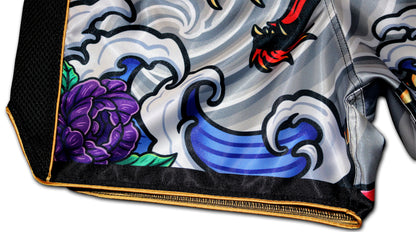 Detailed view of the Irezumi Dragon Muay Thai Shorts, featuring a vibrant purple flower and stylized wave patterns, showcasing the intricate artwork and premium stitching