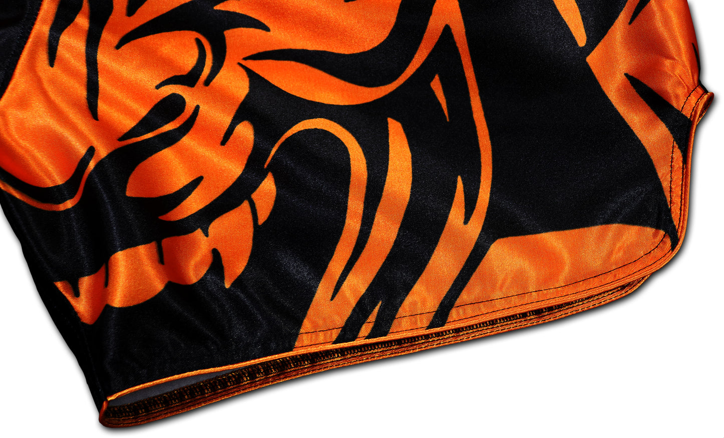 Close-up picture of a Black and Orange Samurai Muay Thai Boxing Shorts highlighting the reinforced seams and border